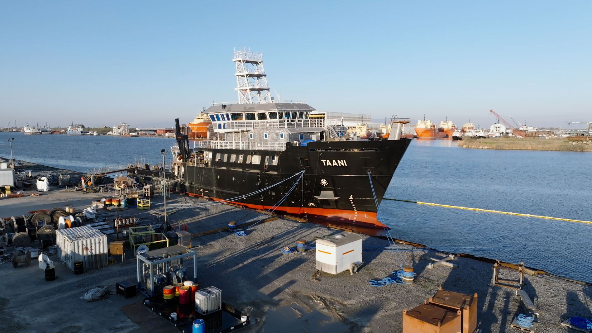 A massive ship rests at the dock, gently floating on the water's surface